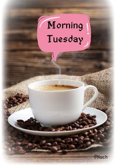 a cup of coffee sitting on top of a pile of coffee beans with the words morning thursday above it