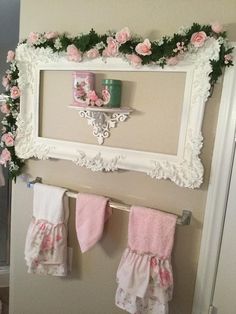 a bathroom decorated in pink and white with flowers