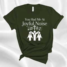 "This Christian faith t-shirt is the perfect gift for the choir director, church worship leader, and church music leader. It features the quote \"You Had Me At Joyful Noise.\" Express your faith and share with others the Gospel of Jesus Christ when you wear this tee. This soft cotton Bella Canvas t-shirt has side seams that help hold the garment's shape longer and give it structural support. The t-shirt has a ribbed knit collar to bolster shaping. The shoulders have taping for a better fit over Church Songs, Church Worship, The Gospel Of Jesus Christ, Choir Director, Joyful Noise, Church Music, Worship Leader