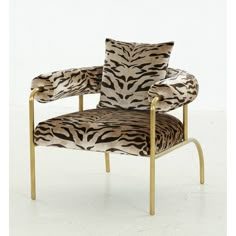 a zebra print chair with gold legs and arms