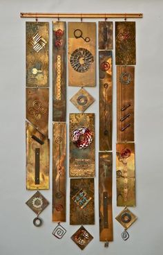 an assortment of metal pieces hanging on the wall