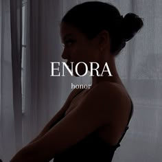 a woman standing in front of a window with the words enora above her head