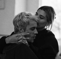 two women are hugging each other in black and white