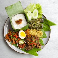 a plate with rice, meat and vegetables on it