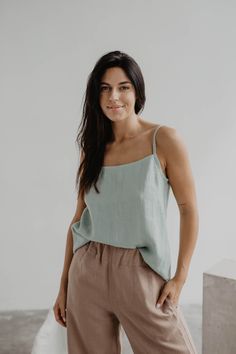 "Elegant, classy linen top. Sleeveless and with a round neckline. Perfect for every occasion - you can wear it to work, the beach or even a night out! Details This listing is for 1 HILO top Agne's height is 177 cm/5'8\" and she is wearing sage green Hilo top in size L for a more oversized look Available in XS, S, M, L, XL. We recommend buying one size up as this model sizes on the smaller side Made from 100% certified European linen Stone washed for maximum softness Available in 11 colors Please Solid Linen Sleeveless Tank Top, Sleeveless Linen Tank Top, Solid Color Linen Sleeveless Tank Top, Casual Flax Linen Tank Top, Sleeveless Linen Camisole For Vacation, Summer Linen Camisole Tank Top, Solid Linen Summer Tank Top, Chic Linen Top In Flax Color, Spring Linen Summer Camisole