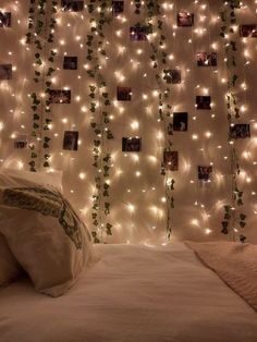 a bedroom decorated with lights and pictures on the wall