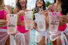 three women in bathing suits hold up their cell phones with the word bride written on them