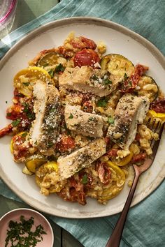 a white plate topped with pasta and chicken