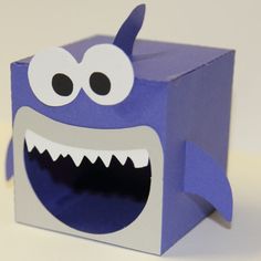 a paper box with a monster face on it's side and eyes open to show teeth