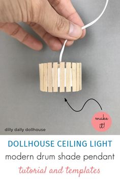 the dollhouse ceiling light is made out of wooden sticks and attached to a string