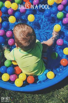 a toddler in a pool filled with lots of colorful balls and text that reads, balls in a pool