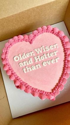 a heart shaped cake in a box that says older wise and hoter than ever