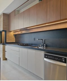 a modern kitchen with stainless steel appliances and wood cabinets