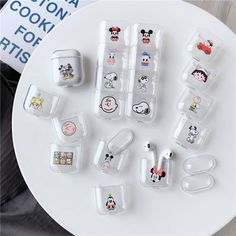 an assortment of mickey mouse airpods on a table