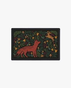 a door mat with foxes and leaves on the front in red, green and yellow colors