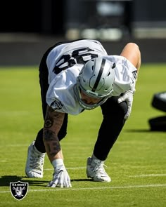 a football player bending down on the field