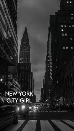 new york city girl in black and white with the empire building in the background at night