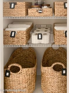 two baskets with labels on them are in the closet