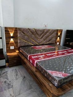 a bed that has been made and is sitting on a wooden platform in the middle of a room