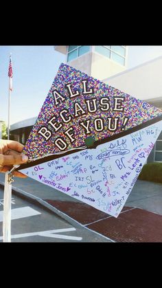 someone holding up a kite with writing on it