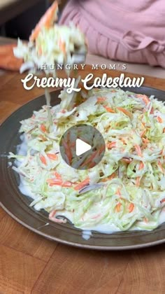 a plate full of coleslaw on top of a wooden table with the words hungry mom's creamy coleslaw