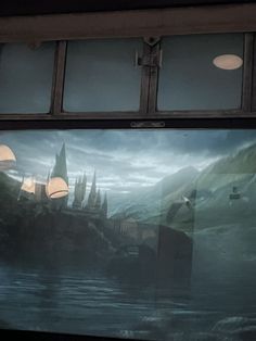 the reflection of a castle in a window on a train car's side wall