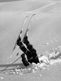 two skiers are upside down in the snow with their skis attached to their feet