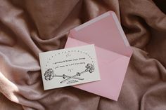 a pink envelope with a card on it