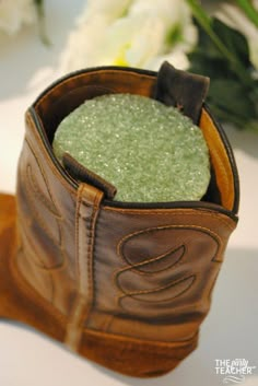 a brown leather boot with some green stuff in it