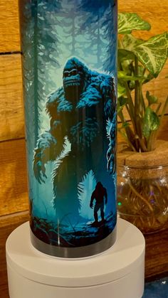 a glass vase with a painting of a bigfoot on it's front and side