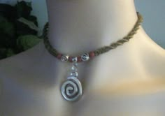 "This hemp necklace design is created using a spiral weave featuring a 1\" silver metal swirl attached to a silver metal bail with tiny swirls and wooden beads accents. This necklace is finished with a double loop and wooden bead closure. The color featured is Sage hemp and is available in several other color choices. 1/75" Interesting Necklace, Hemp Choker, Spiral Necklace, Hemp Necklace, Necklace Design, Funky Jewelry, Swag Style, Circle Of Life, Cool Necklaces