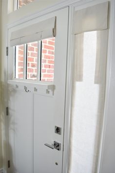 an open white door with blinds on it