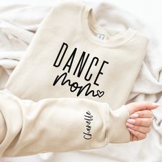 If you are in your dance mom era then these sweatshirts are meant for you. These cozy sweaters are made with a fleece lined unisex style pullover.  The fit is similar to a women's relaxed style, but if you prefer an oversized look please size up. SHIPPING: All orders will be shipped using USPS ground shipping (2-5 business days) unless you have upgraded. I always aim to get your items out as quickly as possible but if you need something to arrive by a certain time please message me and I'll do my best. SOCIAL MEDIA:   Follow me on Instagram to be the among the first to see new items and snag discounts @thechelleshoppe.  I absolutely love seeing how you style your shirts so please feel free to tag me! **CARE INSTRUCTIONS** To ensure the shirt and its design maintain a quality appearance ple Dance Shirt, Dance Studio Shirts, Dance Team Sweatshirts Design, Dance Mom Sweatshirt Ideas, Dance Mom Shirt, Dance Sweatshirt Ideas, Dance Mom Sweatshirt, Dance Mom Gifts, Dance Sweatshirt