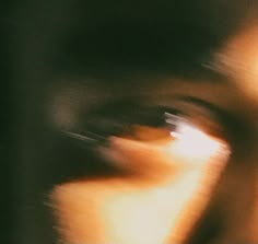 blurry photograph of a person's face and eye