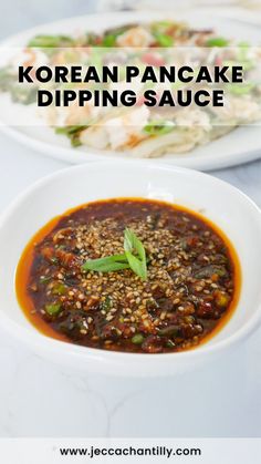 korean pancake dipping sauce in a white bowl on a table with other plates