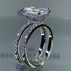 an engagement ring set with a princess cut diamond in the center and matching wedding bands