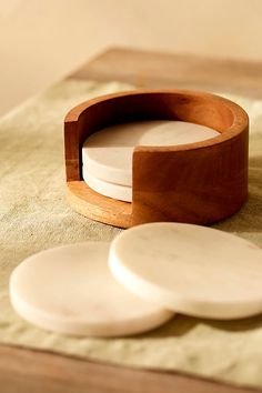 four wooden coasters sitting on top of a table