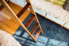 a wooden chair sitting on top of a blue rug