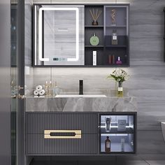 a modern bathroom with marble counter tops and cabinets