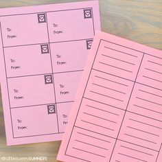 two pink notebooks sitting next to each other on top of a wooden table with writing paper