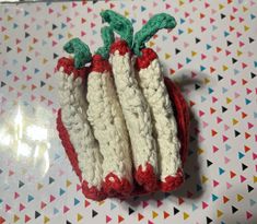 three crocheted vegetables sitting on top of a table