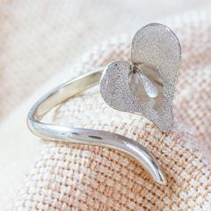 Shaped like both a calla lily blossom and a heart, this adjustable wrap ring is simply gorgeous. Edna Manzano in Mexico designs the accessory, which is crafted from sterling silver with a combination of textured and matte finishes. Sterling Silver Flower Shape Jewelry For Valentine's Day, Flower-shaped Sterling Silver Jewelry For Mother's Day, Calla Lily Earrings, Lily Ring Jewelry, Calla Lily Jewelry, Mexico Design, Silver Wrap Ring, Wrap Ring, Wrap Rings