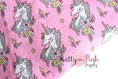 the pink unicorns are all over the bed sheet