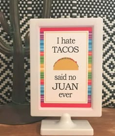 a sign that says i hate tacos said no juan ever in front of a cactus