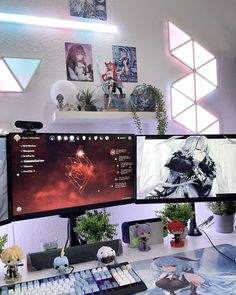 two computer monitors sitting on top of a desk