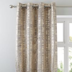 the curtain is hanging in front of a window with white walls and windowsills