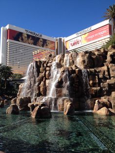 the mirage hotel and casino in las vegas, with water falling from it's fountains