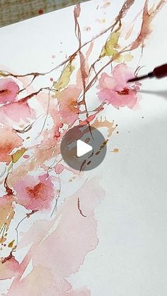 someone is painting flowers with watercolors on paper