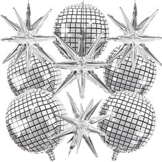 four shiny glass balls are arranged in the shape of a snowflake, on a white background