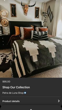 a bed room with a neatly made bed and animal heads on the wall above it